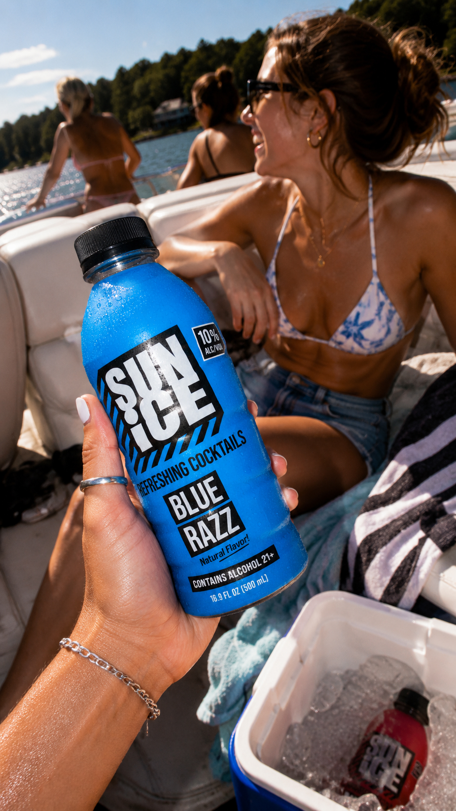 Orange Club and Blue Razz SUN ICE in a fridge with sliced oranges.