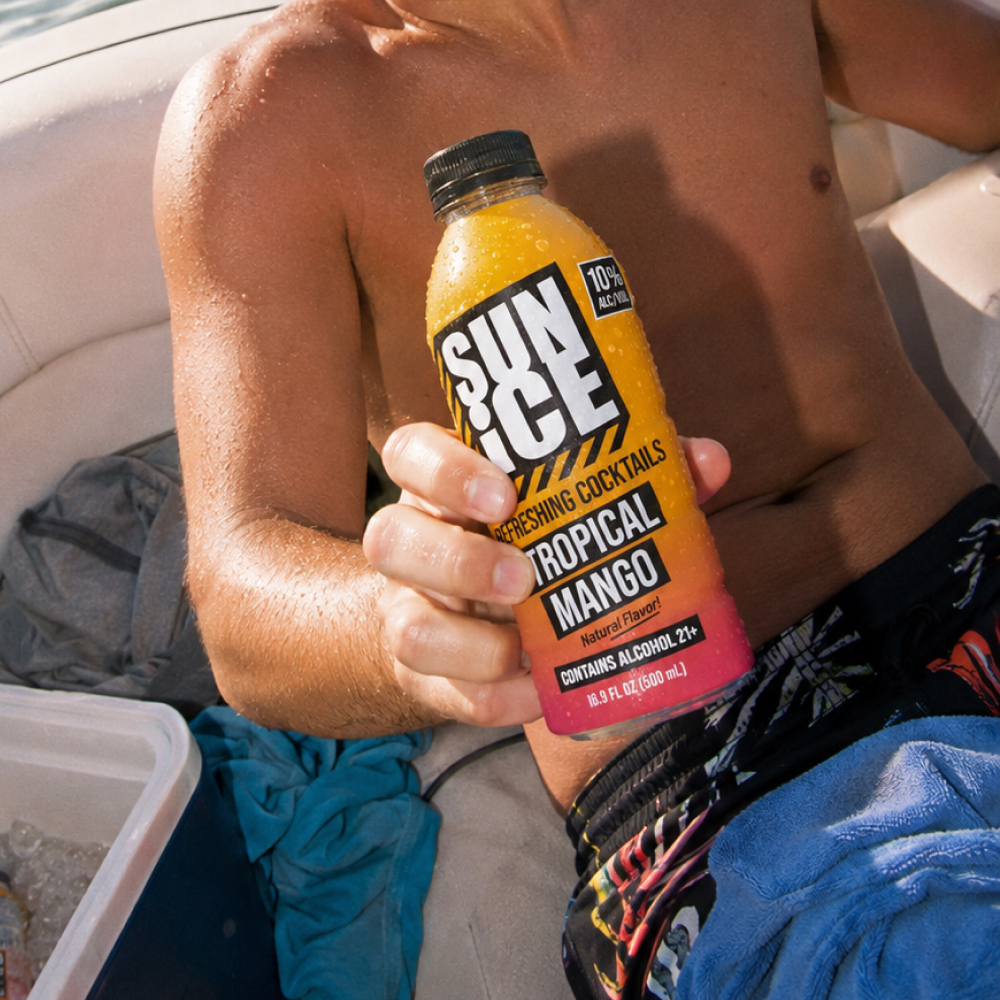 Tropical Mango SUN ICE held on a boat in the sun.
