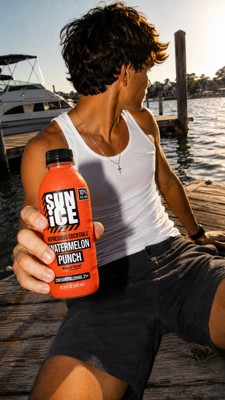 Watermelon Punch SUN ICE on a dock at golden hour.